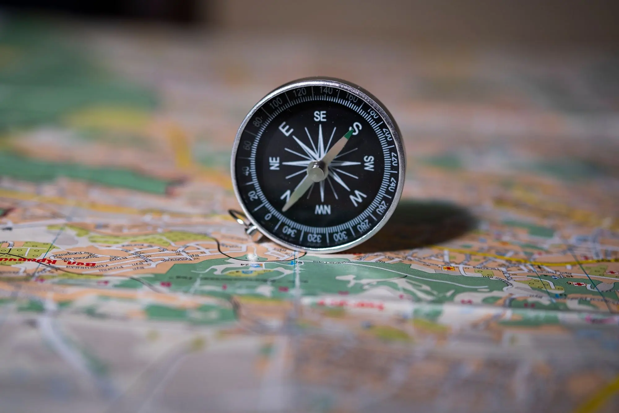 Compass resting on a map